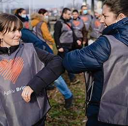 Two women greeting with their elbows