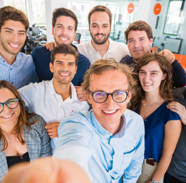 A group of eight Aptiv employees smiling