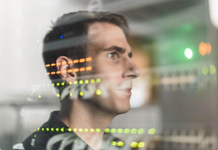 Profile of a man looking into technology