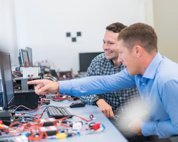 Two engineers working on a pc