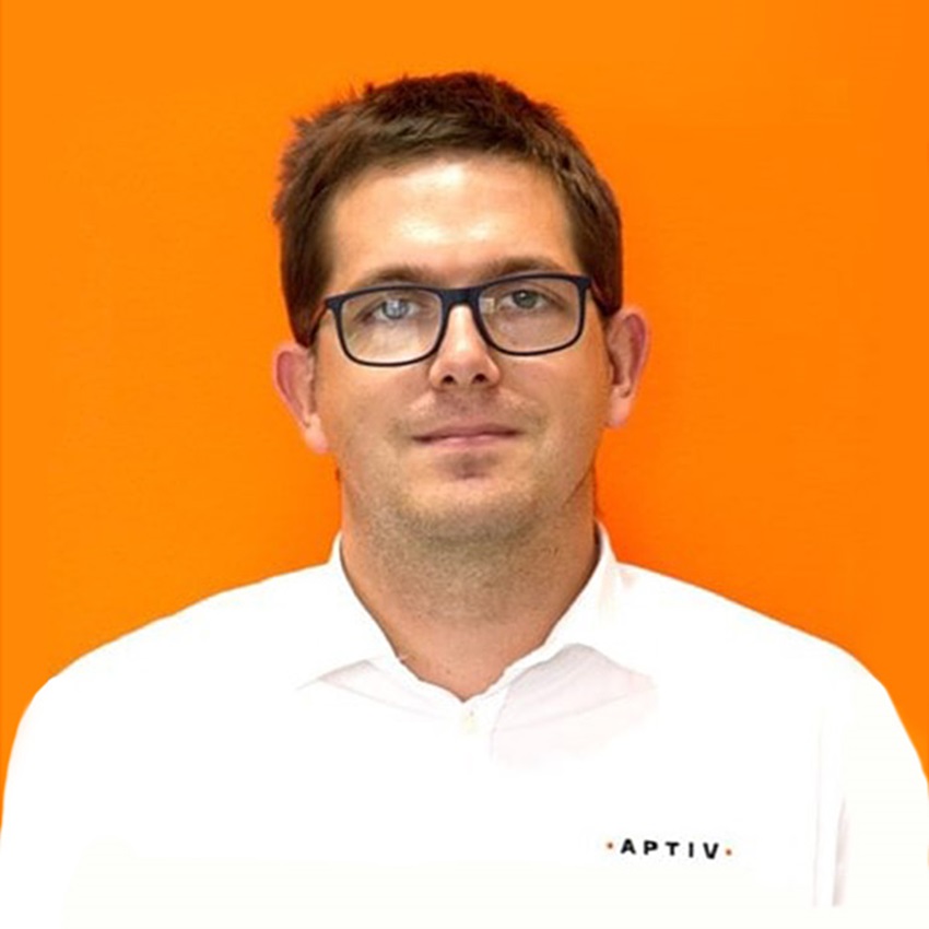 Man with glasses in white shirt on orange background