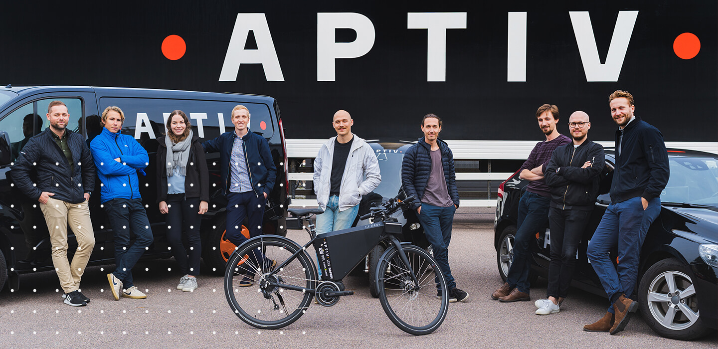 Aptiv team with a car, bicycle and a van