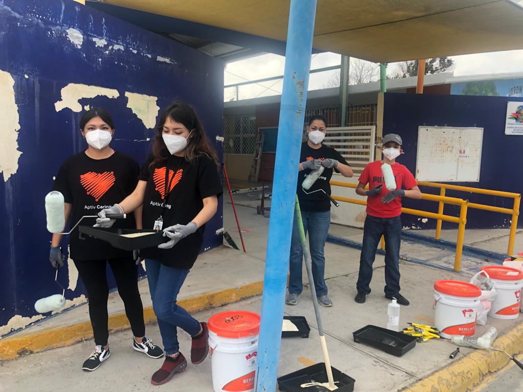 Aptiv employees painting a kindergarten in Mexico in March 2022.
